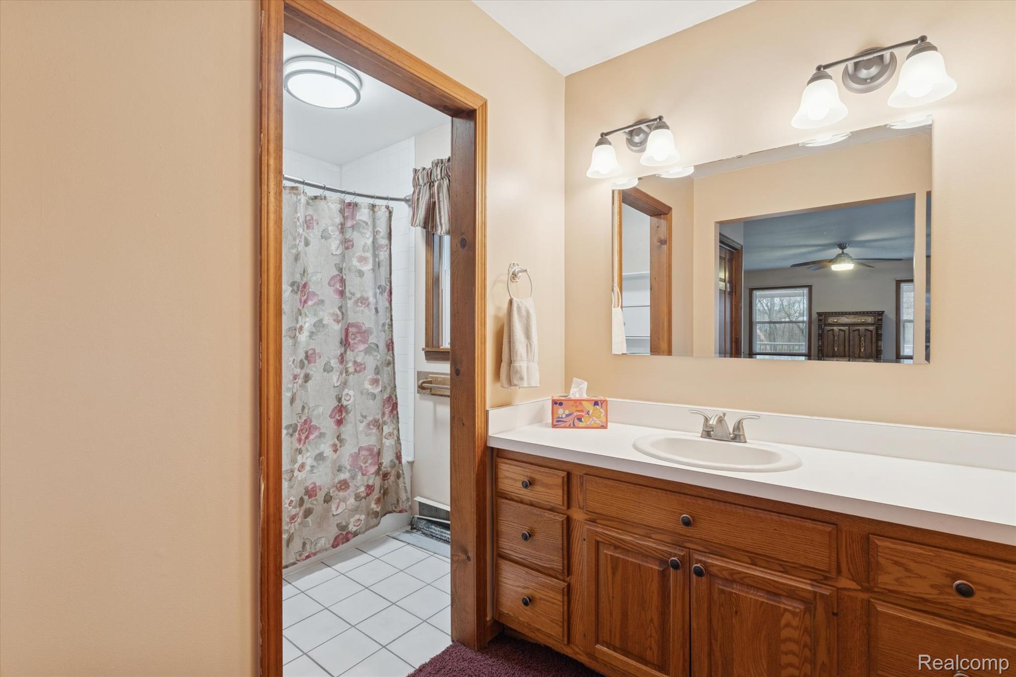 3031 Cedar Point Howell, MI 48843 - Photo 20 of 51 Bathroom featuring light tile patterned floors, vanity, and ceiling fan