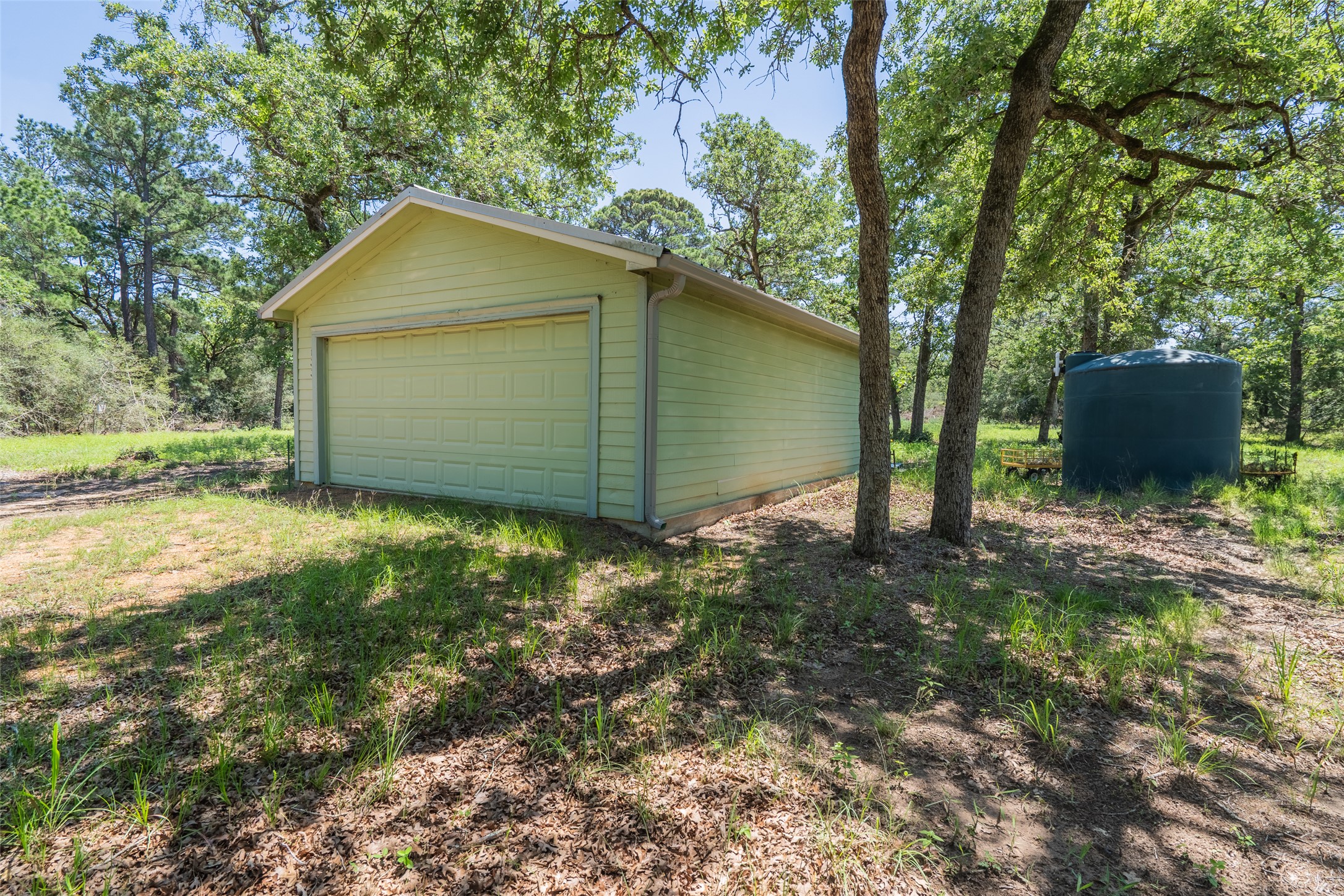 133 Roundup Ridge Smithville, TX 78957 - Photo 1 of 11 Secure garage storage while building. Water cistern available for any additional burn clearing.