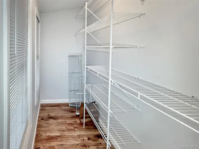 a view of a room with wooden floor and bench