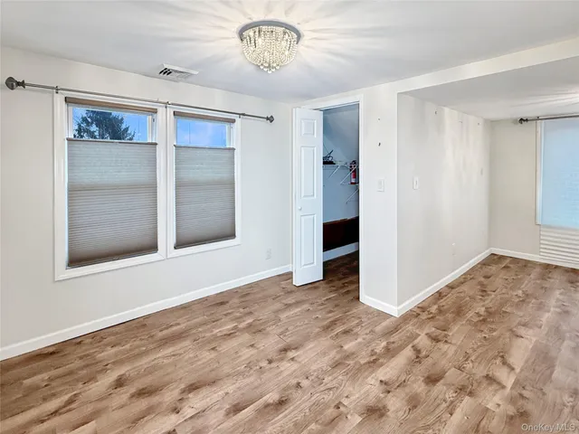 a view of a hallway view with wooden floor and staircase
