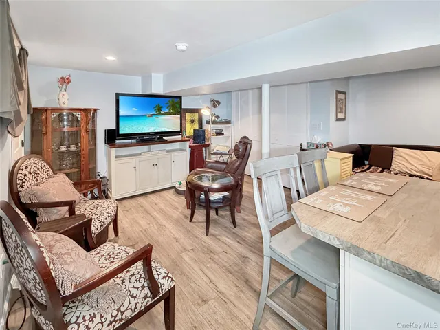 a kitchen with a table chairs refrigerator and microwave