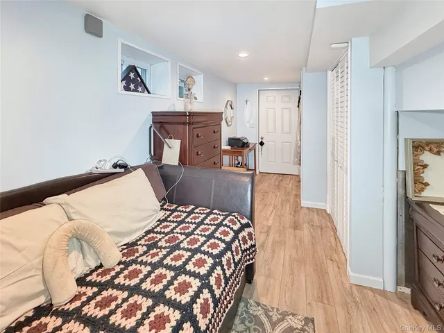 a living room with furniture a flat screen tv and kitchen view