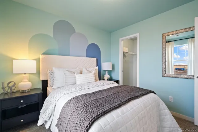 a bathroom with a granite countertop sink a toilet a mirror and shower