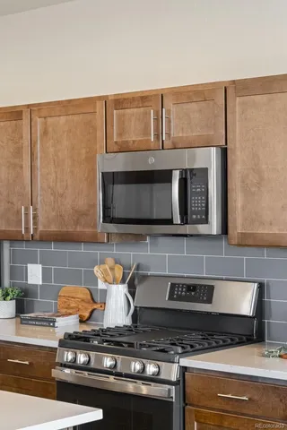 a stove top oven sitting inside of a kitchen