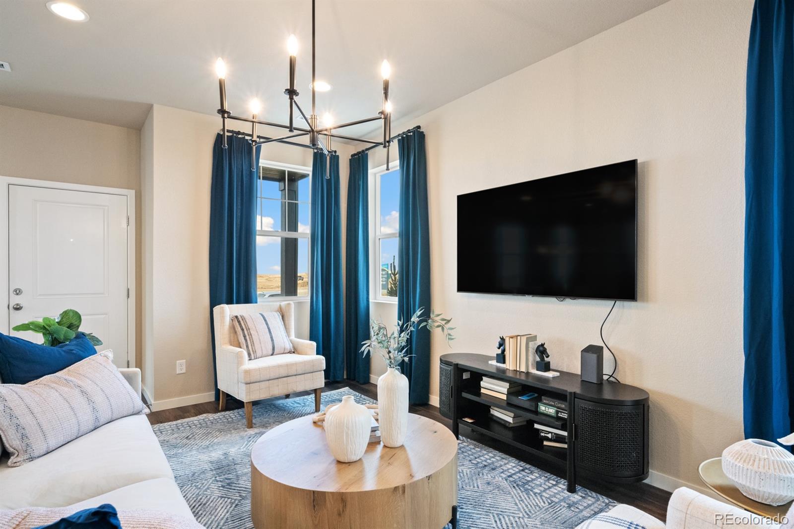 824 North Bently Street Watkins, CO 80137 - Photo 6 of 20 a living room with furniture and a flat screen tv