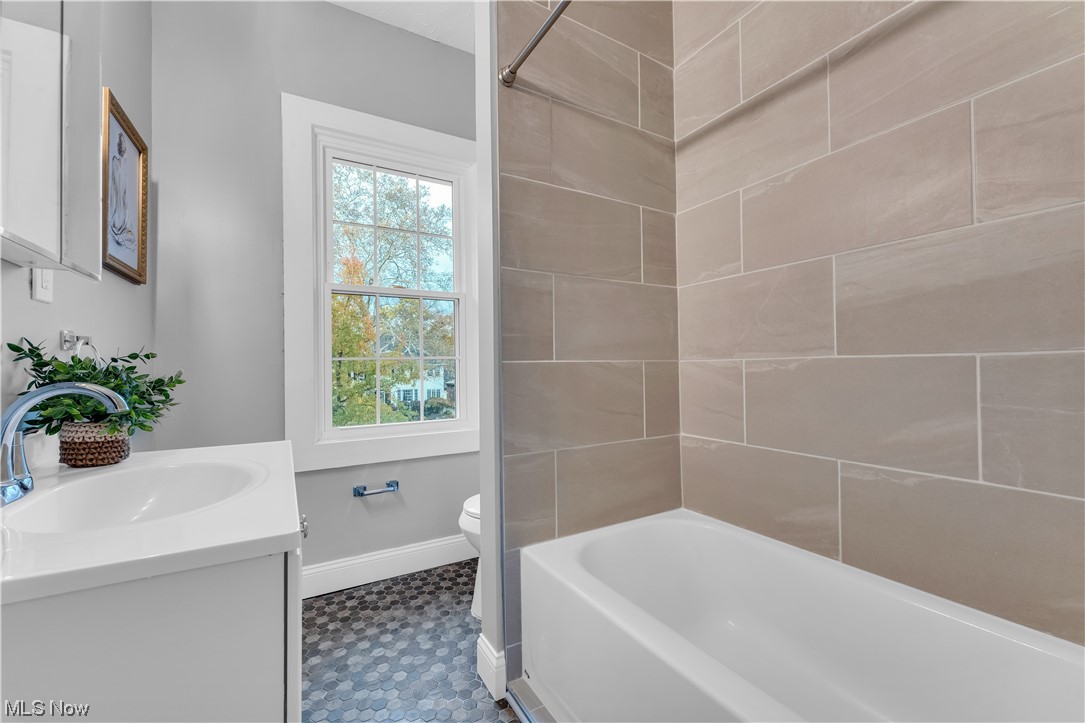 2640 Edgehill Road Cleveland, OH 44106 - Photo 21 of 35 Full bathroom with shower / bathtub combination, toilet, vanity with extensive cabinet space, and tile flooring