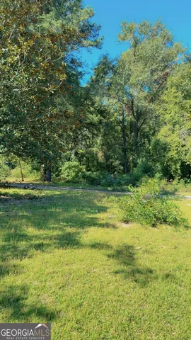 a view of outdoor space with a garden and trees