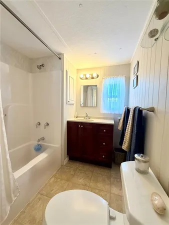 a bathroom with a tub sink and toilet