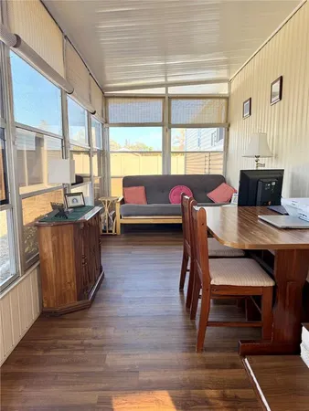 a view of a workspace with furniture and window