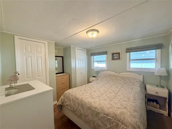 a spacious bedroom with a bed and a dresser in it