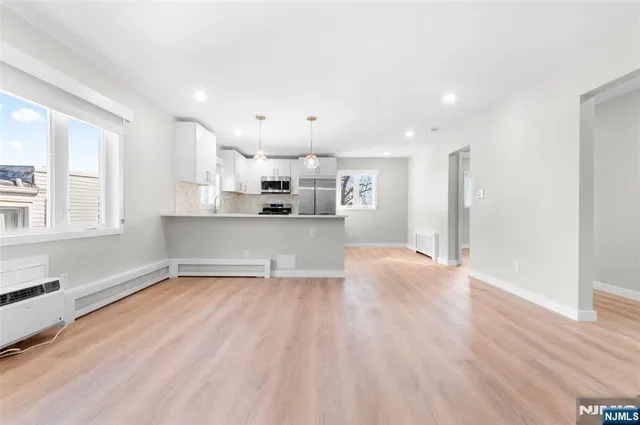 a view of a kitchen with a sink and wooden floor