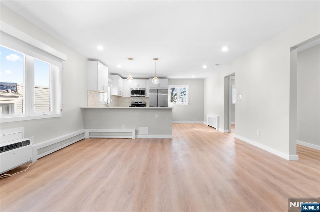 539 Undercliff Avenue, Unit 4 Edgewater, NJ 07020 - Photo 2 of 13 a view of a kitchen with a sink and wooden floor