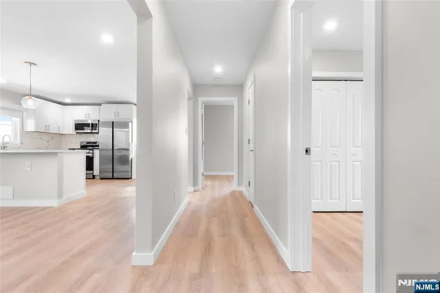 a view of a kitchen with wooden floor