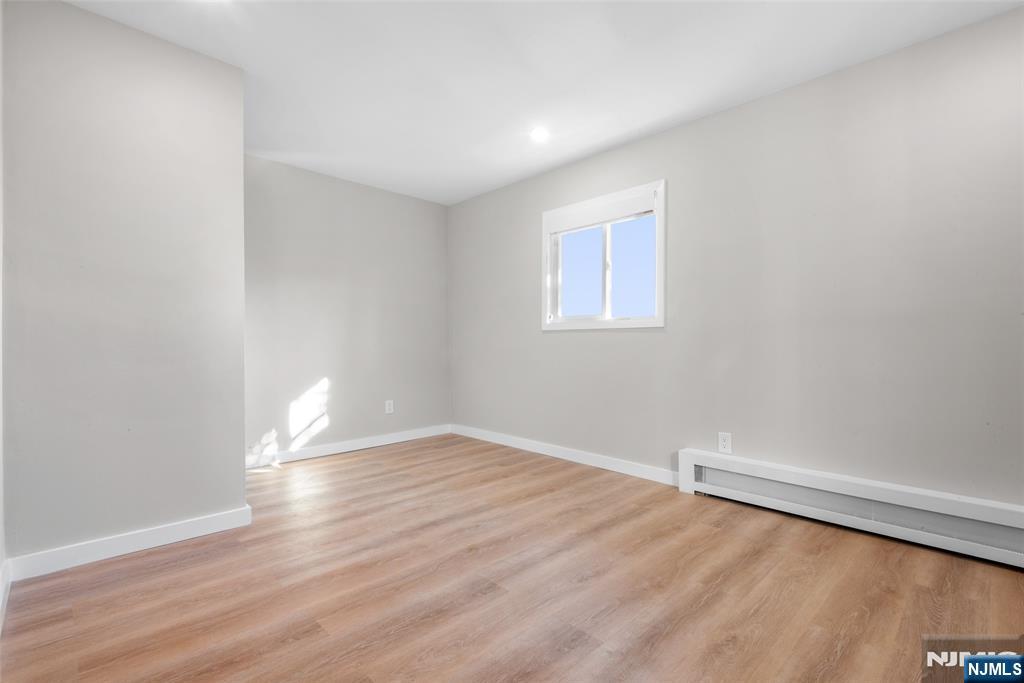 539 Undercliff Avenue, Unit 4 Edgewater, NJ 07020 - Photo 10 of 13 a view of an empty room with wooden floor