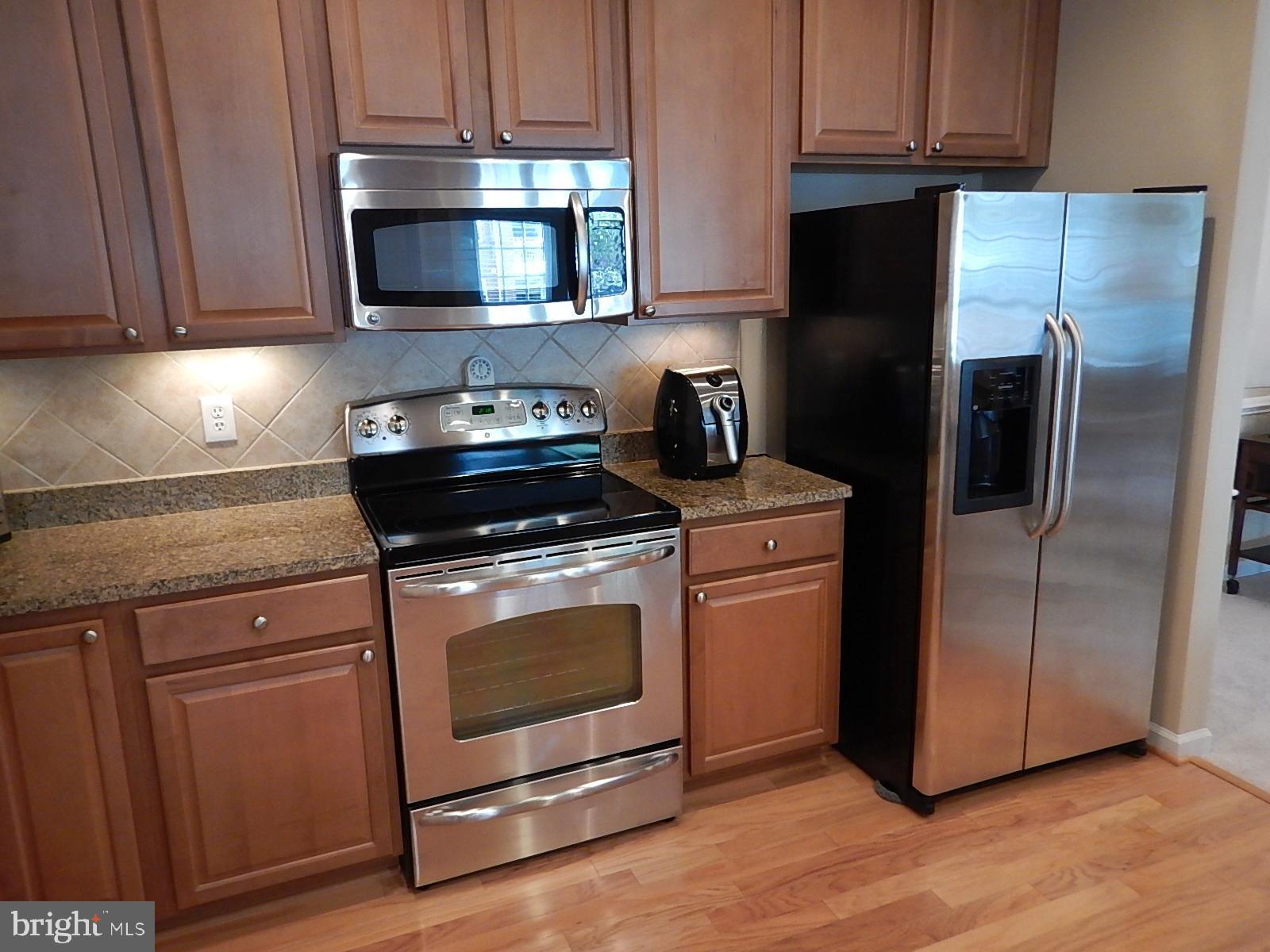 633 Wallingford Road, Unit 201 Bel Air, MD 21014 - Photo 10 of 38 a kitchen with stainless steel appliances granite countertop a stove a refrigerator and a microwave