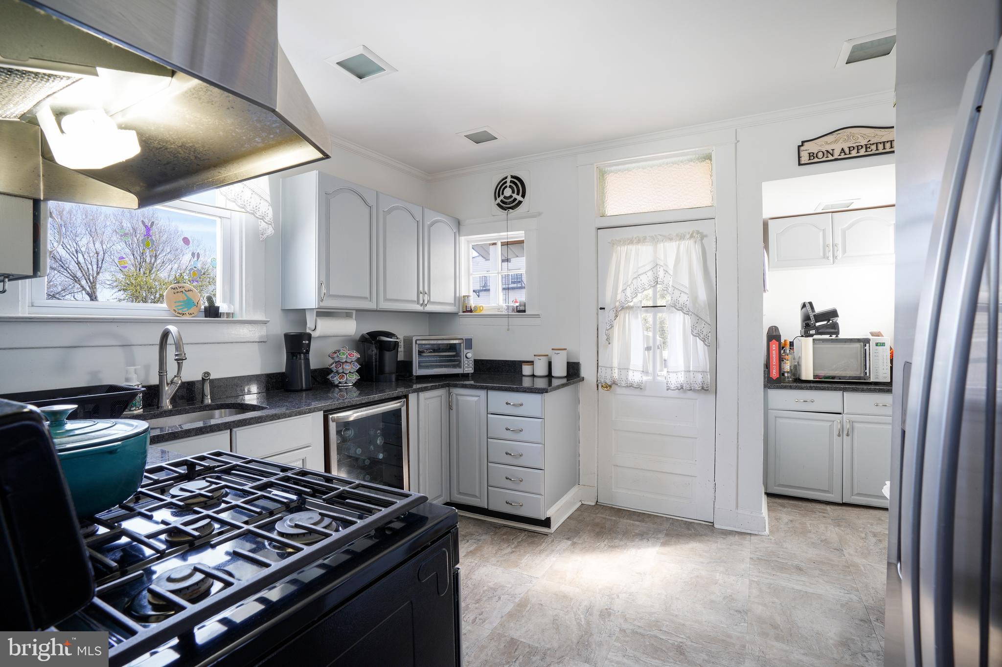 636 North Bend Road Baltimore, MD 21229 - Photo 9 of 26 a kitchen with white cabinets and appliances