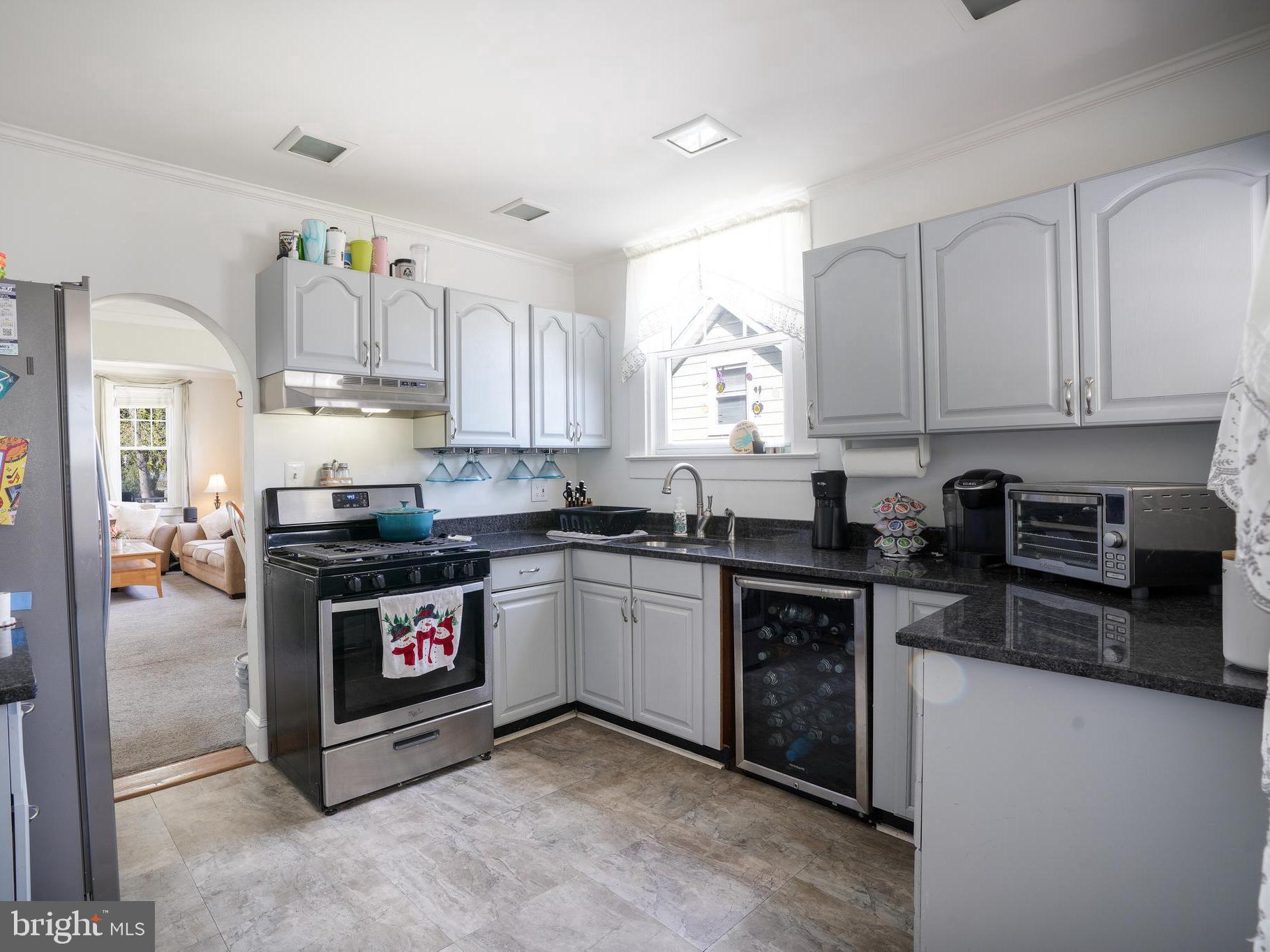636 North Bend Road Baltimore, MD 21229 - Photo 10 of 26 a kitchen with stainless steel appliances granite countertop a stove top oven a sink dishwasher and a microwave oven on the blue kitchen countertops