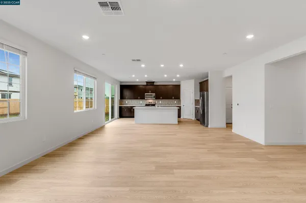 a view of a kitchen with a sink and a refrigerator