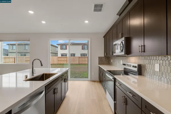 a kitchen with a sink and cabinets