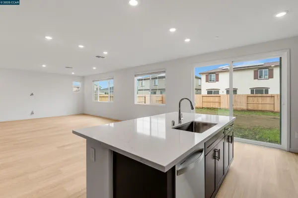 a kitchen with stainless steel appliances a sink stove and microwave