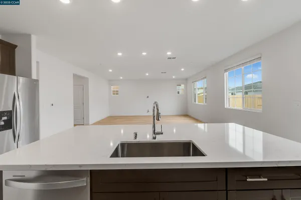 a kitchen with stainless steel appliances granite countertop a refrigerator and a sink