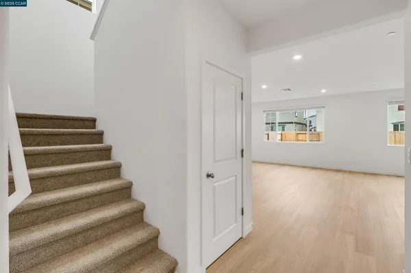 a view of entryway and hall with wooden floor
