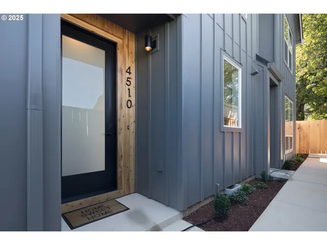 a kitchen with stainless steel appliances a stove a microwave a sink and cabinets