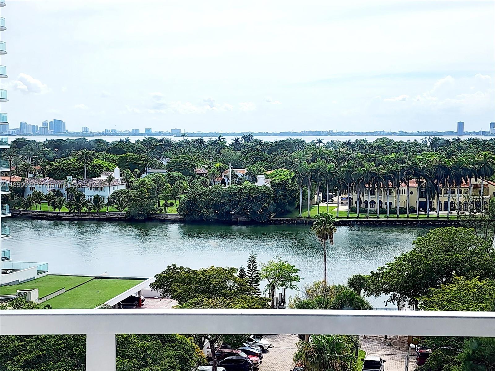 5555 Collins Avenue, Unit 9S Miami Beach, FL 33140 - Photo 13 of 48 an aerial view of residential building lake and houses