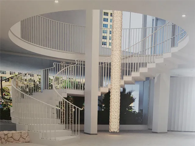 a view of staircase with white walls and stairs