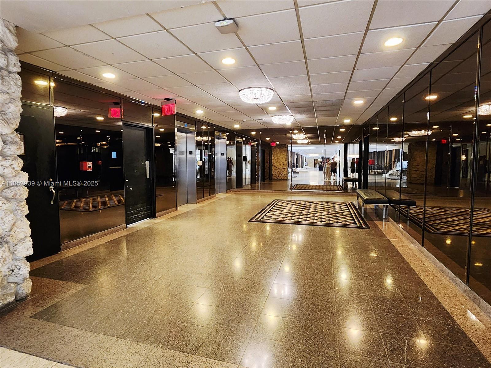 5555 Collins Avenue, Unit 9S Miami Beach, FL 33140 - Photo 27 of 48 a view of a room with gym equipment