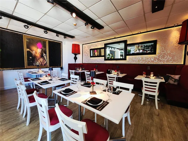 a view of a dining room with furniture wooden floor and chandelier