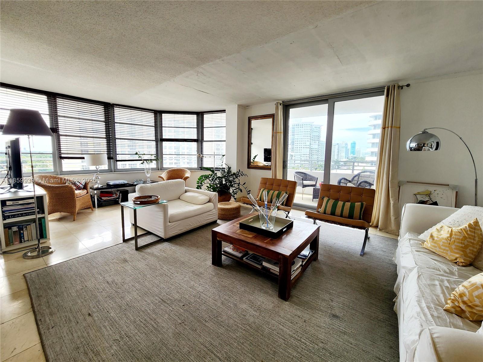 5555 Collins Avenue, Unit 9S Miami Beach, FL 33140 - Photo 7 of 48 a living room with furniture and a large window