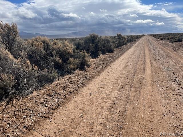 11.5 Tbd County Road San Luis, CO 81152 - Photo 4 of 7 a view of a dry yard with a building in the background