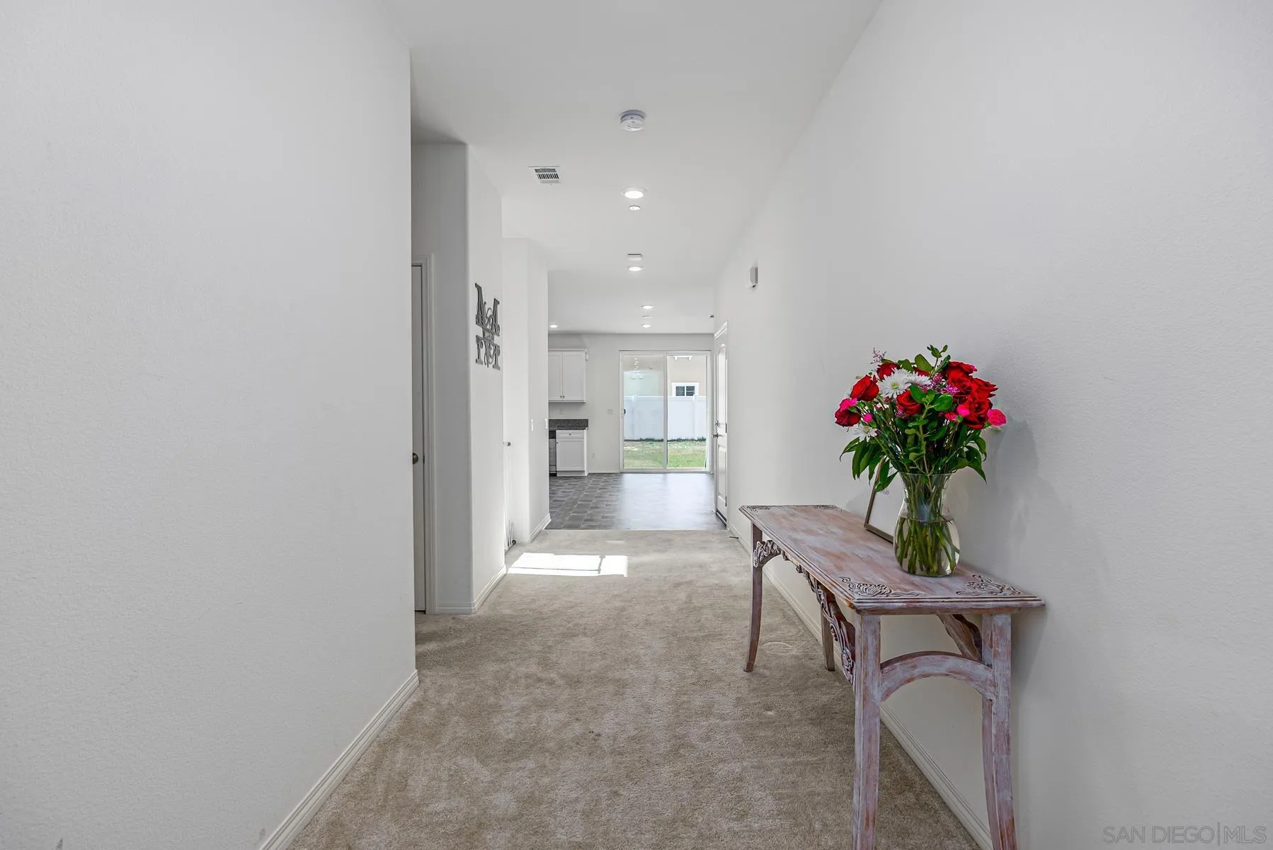 30903 Wild Berry Way Menifee, CA 92584 - Photo 13 of 37 a view of a hallway and a potted plant