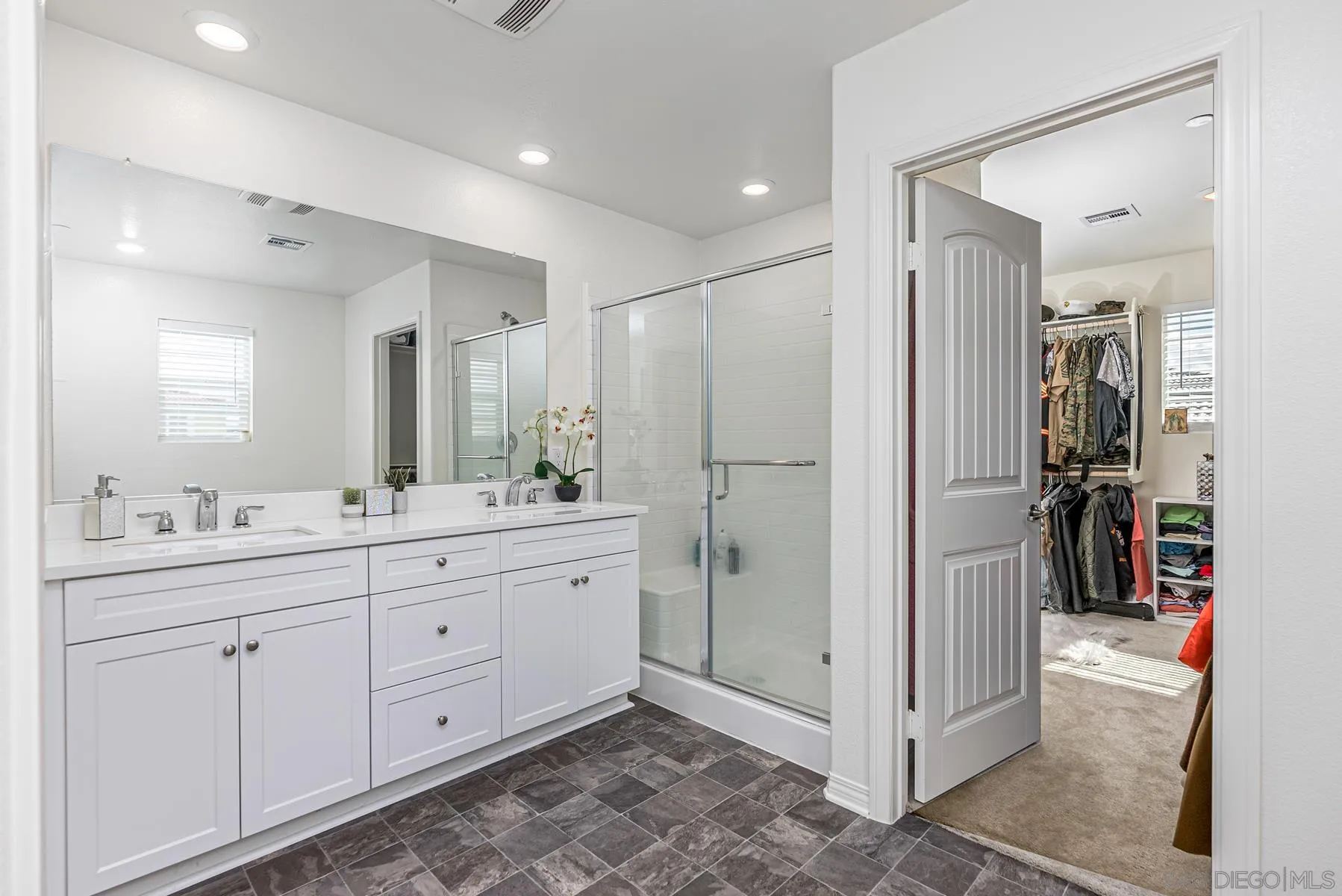 30903 Wild Berry Way Menifee, CA 92584 - Photo 16 of 37 a bathroom with a double vanity sink and a mirror