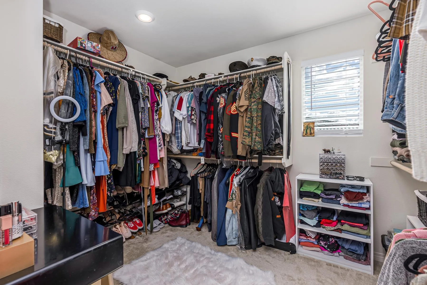 30903 Wild Berry Way Menifee, CA 92584 - Photo 17 of 37 a view of walk in closet with clothes and shoes