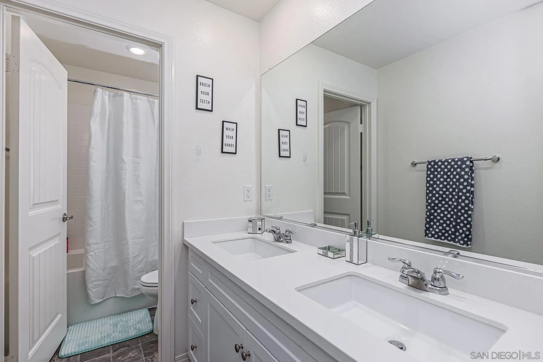 30903 Wild Berry Way Menifee, CA 92584 - Photo 23 of 37 a bathroom with a sink and a mirror