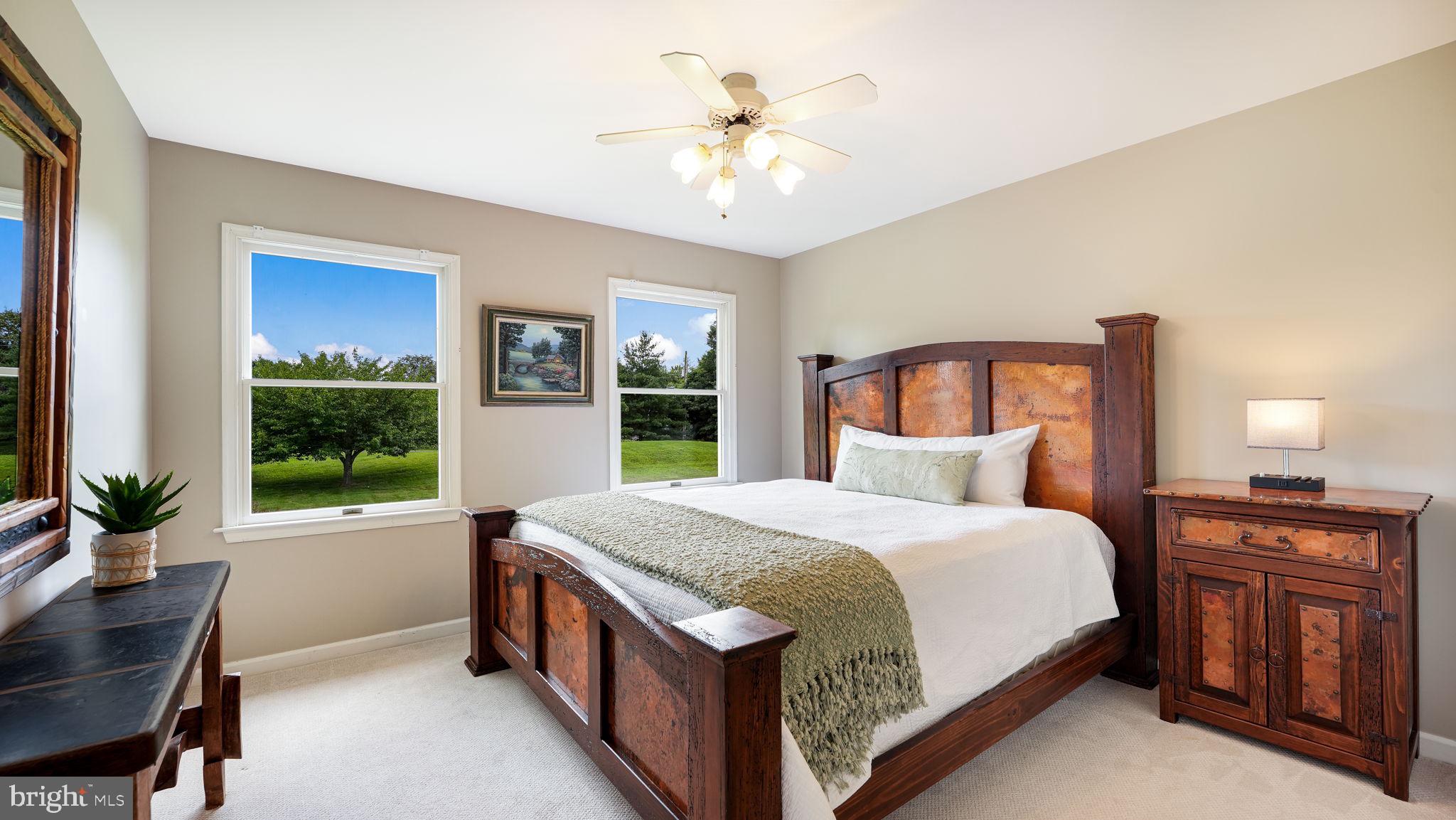 340 West Sandy Ridge Road Doylestown, PA 18901 - Photo 22 of 40 a bedroom with a large bed and a chandelier