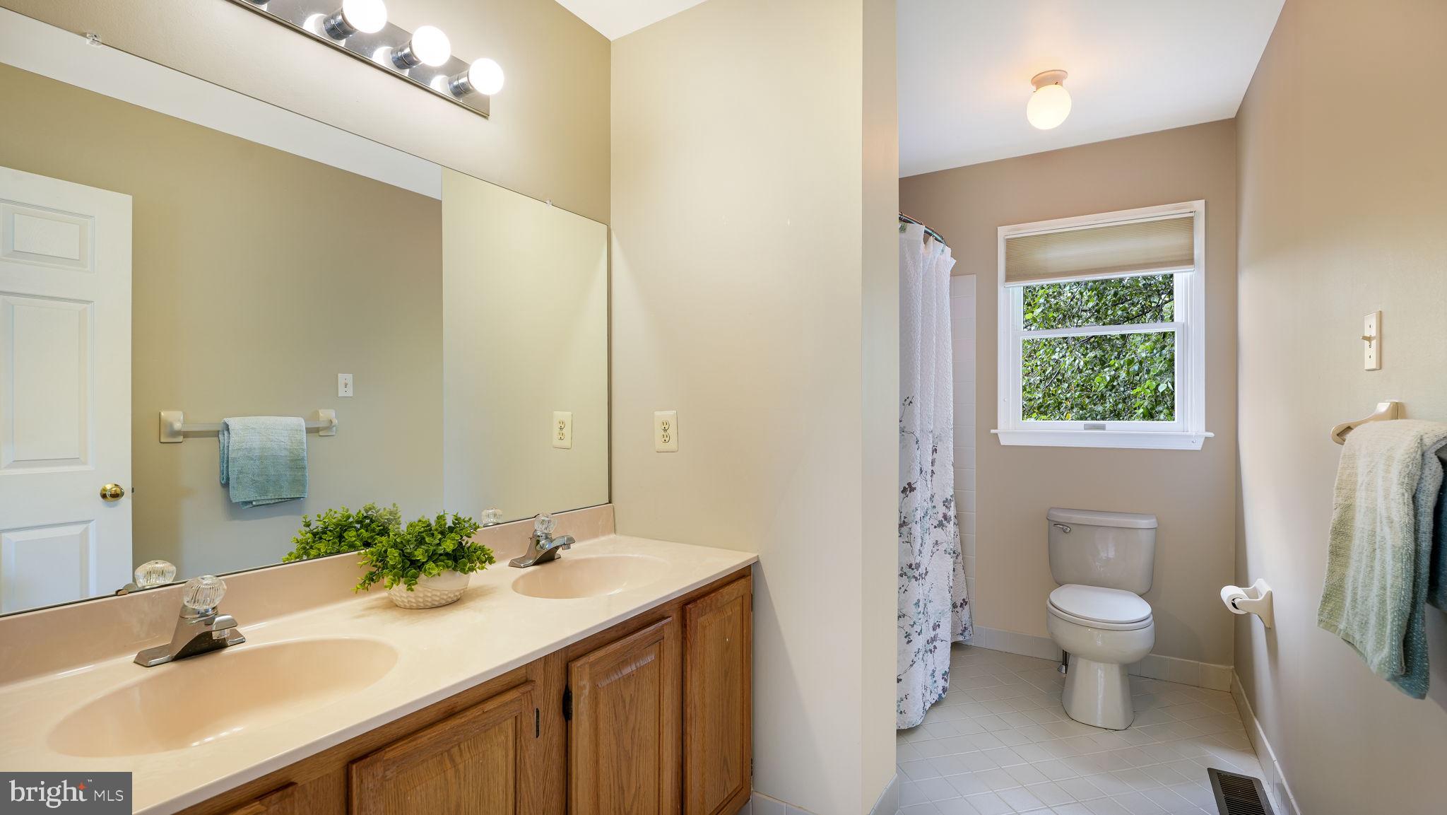 340 West Sandy Ridge Road Doylestown, PA 18901 - Photo 26 of 40 a bathroom with a granite countertop sink a toilet and a large mirror