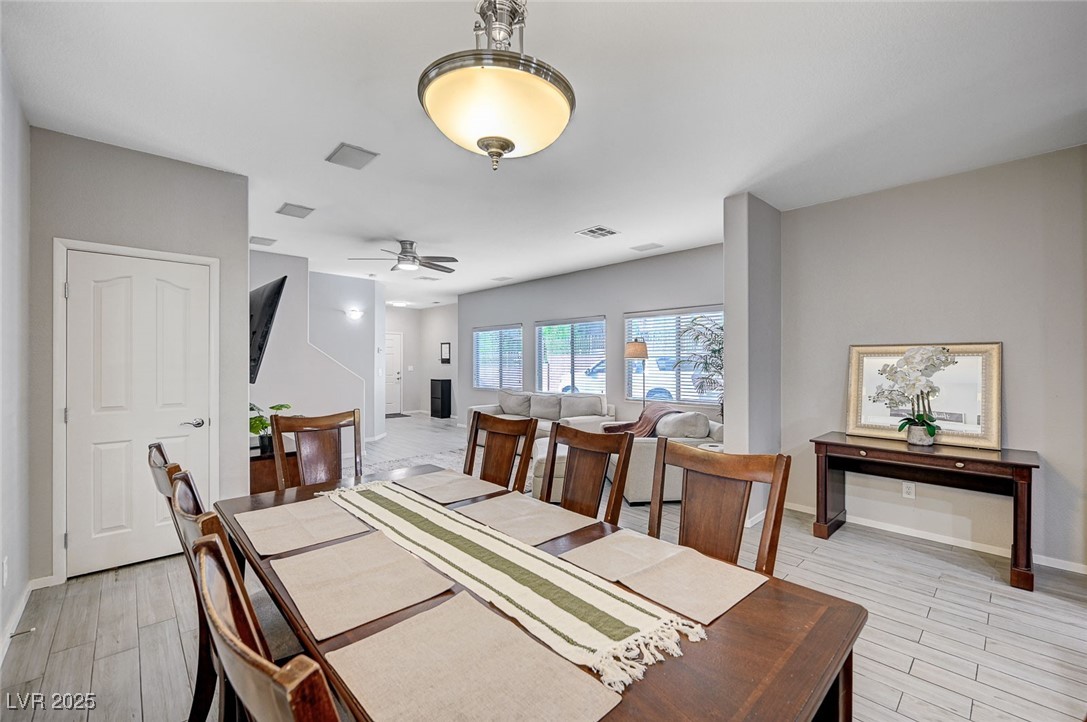9310 Pinarello Street Las Vegas, NV 89178 - Photo 13 of 61 Dining room with light wood-style floors and ceiling fan