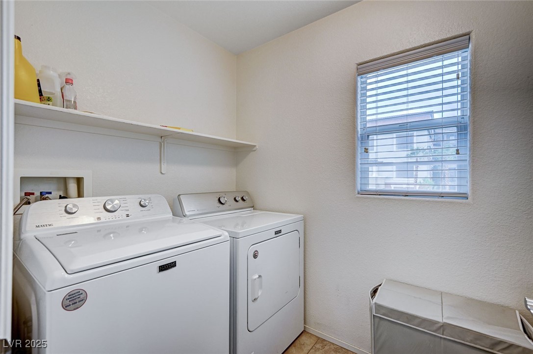 9310 Pinarello Street Las Vegas, NV 89178 - Photo 39 of 61 Laundry area featuring a textured wall and washing machine and dryer