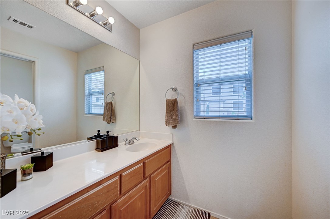 9310 Pinarello Street Las Vegas, NV 89178 - Photo 43 of 61 Bathroom featuring vanity and a textured wall