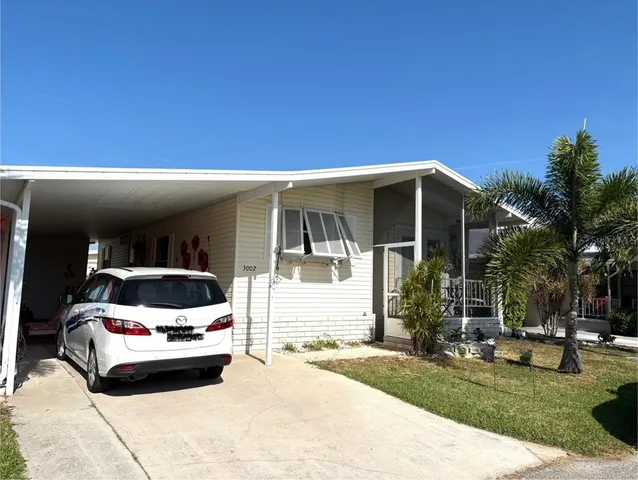 a car parked in front of white house
