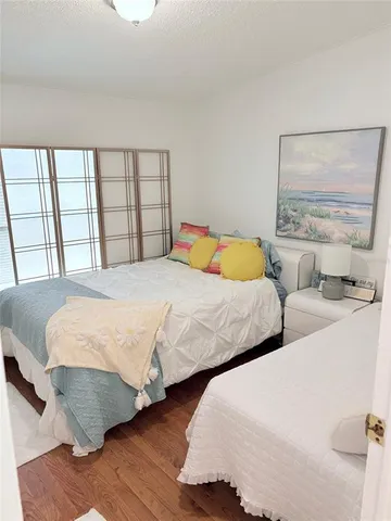 a bedroom with two beds and a large mirror