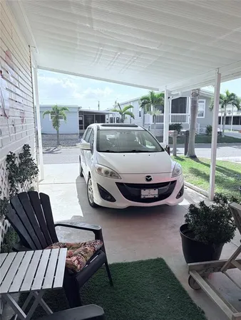 a living room with furniture a red rug and a window