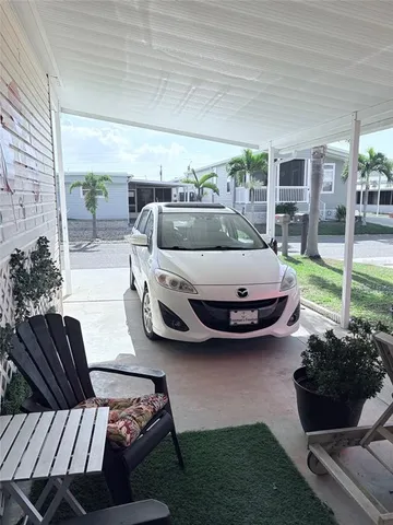 a living room with furniture a red rug and a window