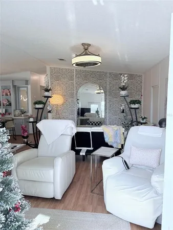 a living room with furniture and a chandelier