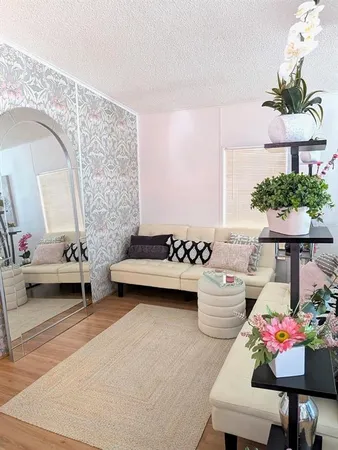 a living room with furniture and a potted plant