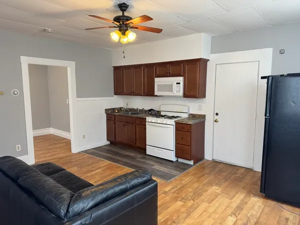 a kitchen with stainless steel appliances granite countertop a stove a sink dishwasher and a refrigerator