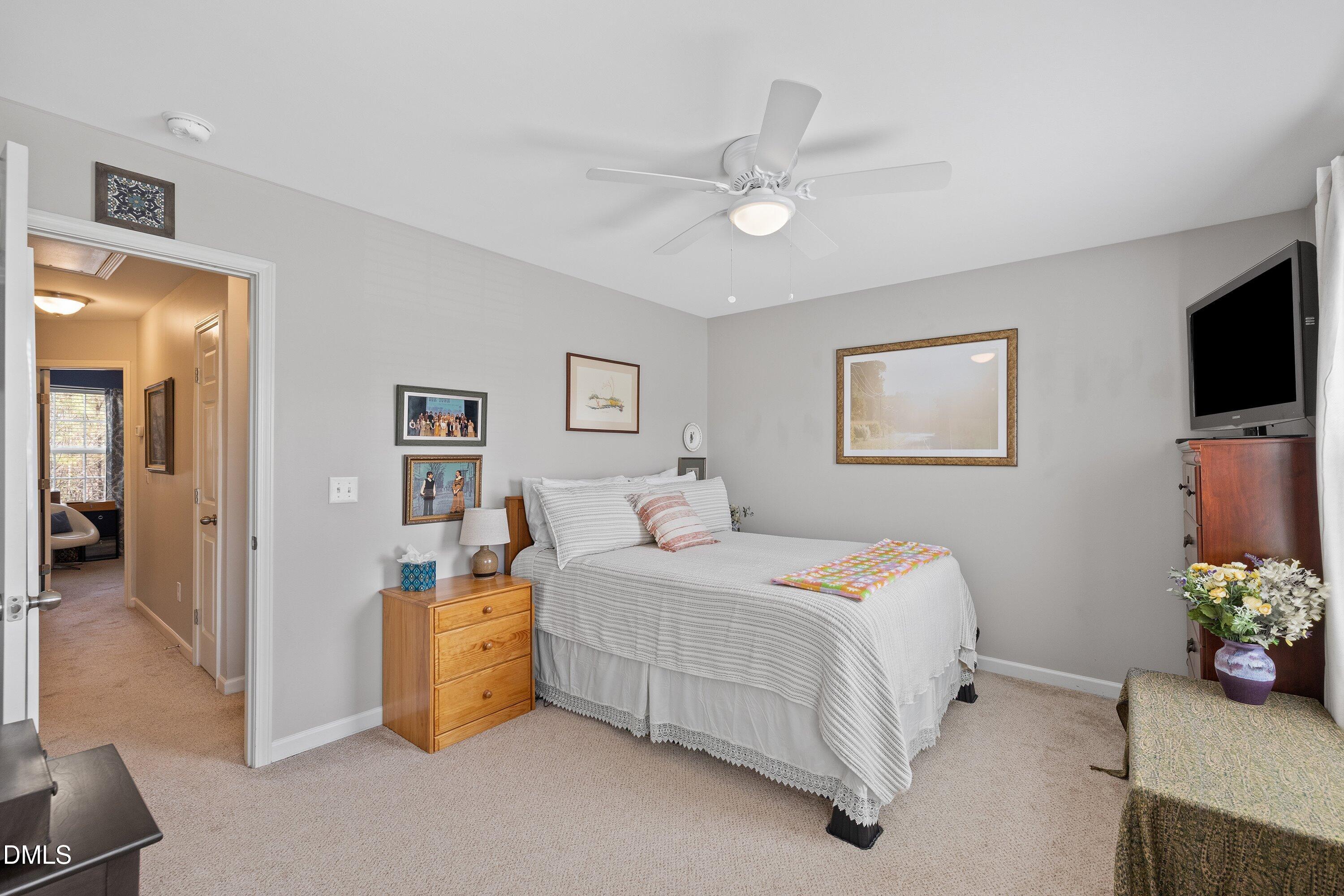 1093 Renewal Place Raleigh, NC 27603 - Photo 20 of 45 a bedroom with a bed and a flat screen tv